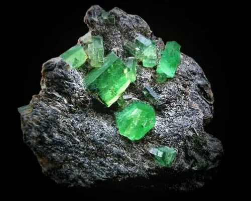 Close-up of emerald showing textures on neutral background