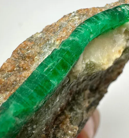 Emerald color variations under office and natural light