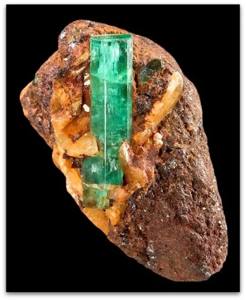 Emerald pendant against complementary purple silk