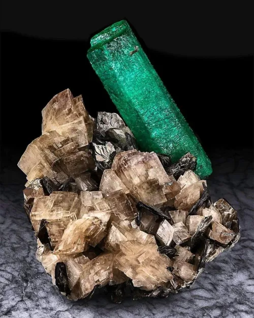 Emerald ring in various lighting conditions showing color shifts