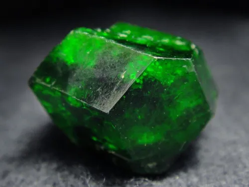 Emerald ring worn in three lighting scenarios