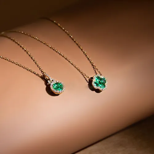 Close-up of an emerald gemstone showing how its green color changes under different light sources.